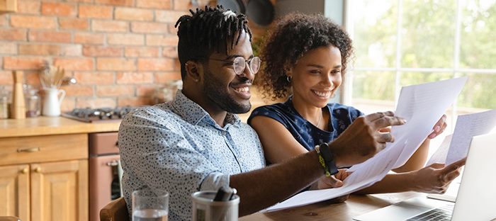 Man and woman looking over mortgage papers.
