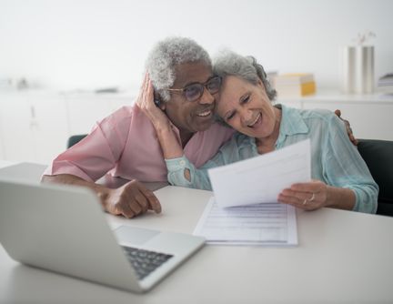 A senior couple reviewing documents together at a desk